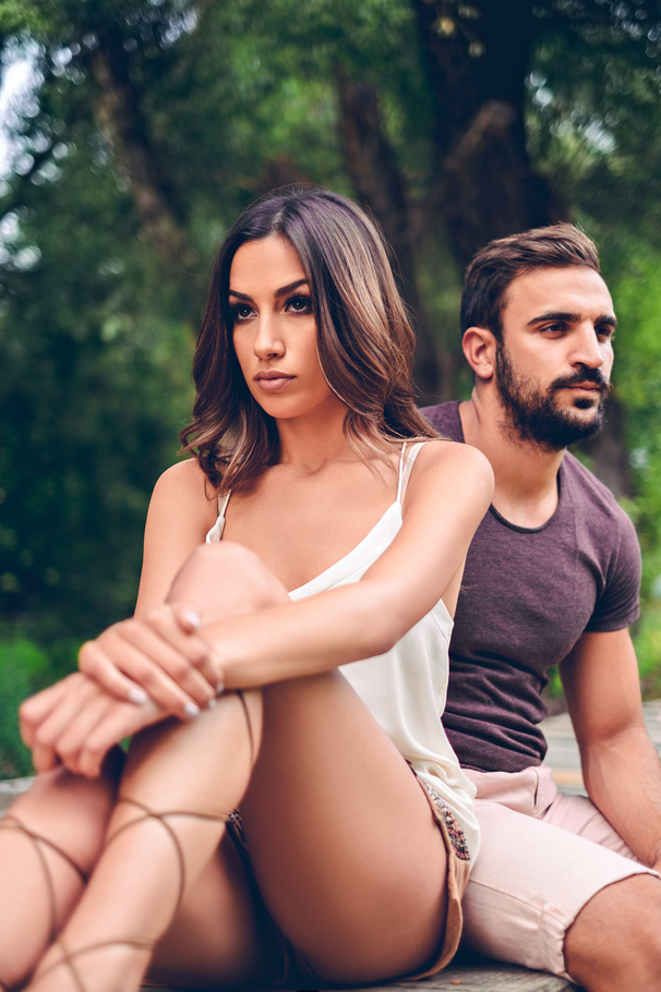 Angry couple sitting in the park